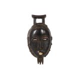 A YAURE MASK, IVORY COAST  The wood with a dark lustrous patina, the face has slit eyes with half