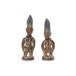 A PAIR OF YORUBA TWIN FIGURES  Of Ibeji wood with a fine smooth patina, depicted in the