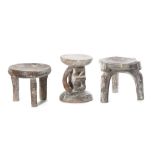 THREE WOOD STOOLS  Including two three-legged stools with circular seats and one with a circular