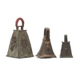 THREE BENIN BRONZE BELLS The largest with a cloth covered handle and raised relief design with