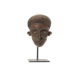 A CHOKWE WOOD MASK, DEMOCRATIC REPUBLIC OF CONGO With a large rounded headdress covered in incised