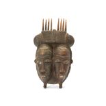 A TWIN BAULE MASK, IVORY COAST Of diminutive size, this mask has twin narrow faces with identical
