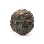 AN INDIAN METAL MASK  A circular mask with exaggerated facial features, with bulbous cheeks and