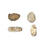 A GROUP OF PREHISTORIC IMPLEMENTS Including a large hand axe with a pale grey surface, curved at