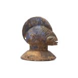 A YORUBA HEADPIECE, NIGERIA Raised on a circular base with holes for attachment of the crest to a