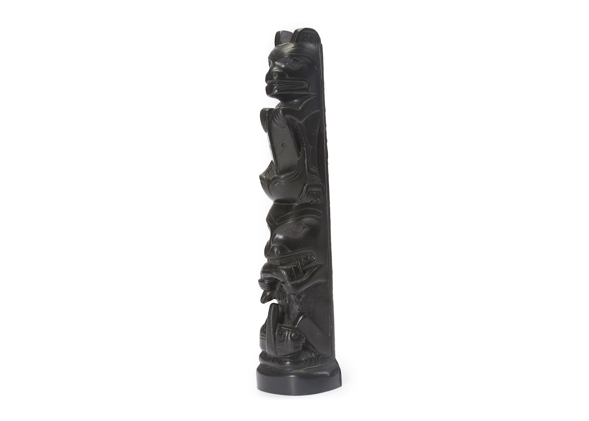 AN ARGILLITE TOTEM, HAIDA TRIBE In the form of two seated bears atop one another, 19.7cm high,
