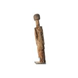 A HIGHLY STYLISED WOOD FIGURE Circa late 19th century Carved in light wood with a textured
