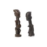 TWO AFRICAN WOOD FEMALE FIGURES Of unknown origin, One figure kneels with her hands resting on her