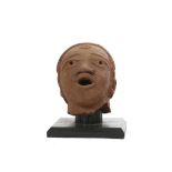 AN IFE COMMEMORATIVE MALE HEAD, NIGERIA A large earthenware male head with an open mouth, broad nose