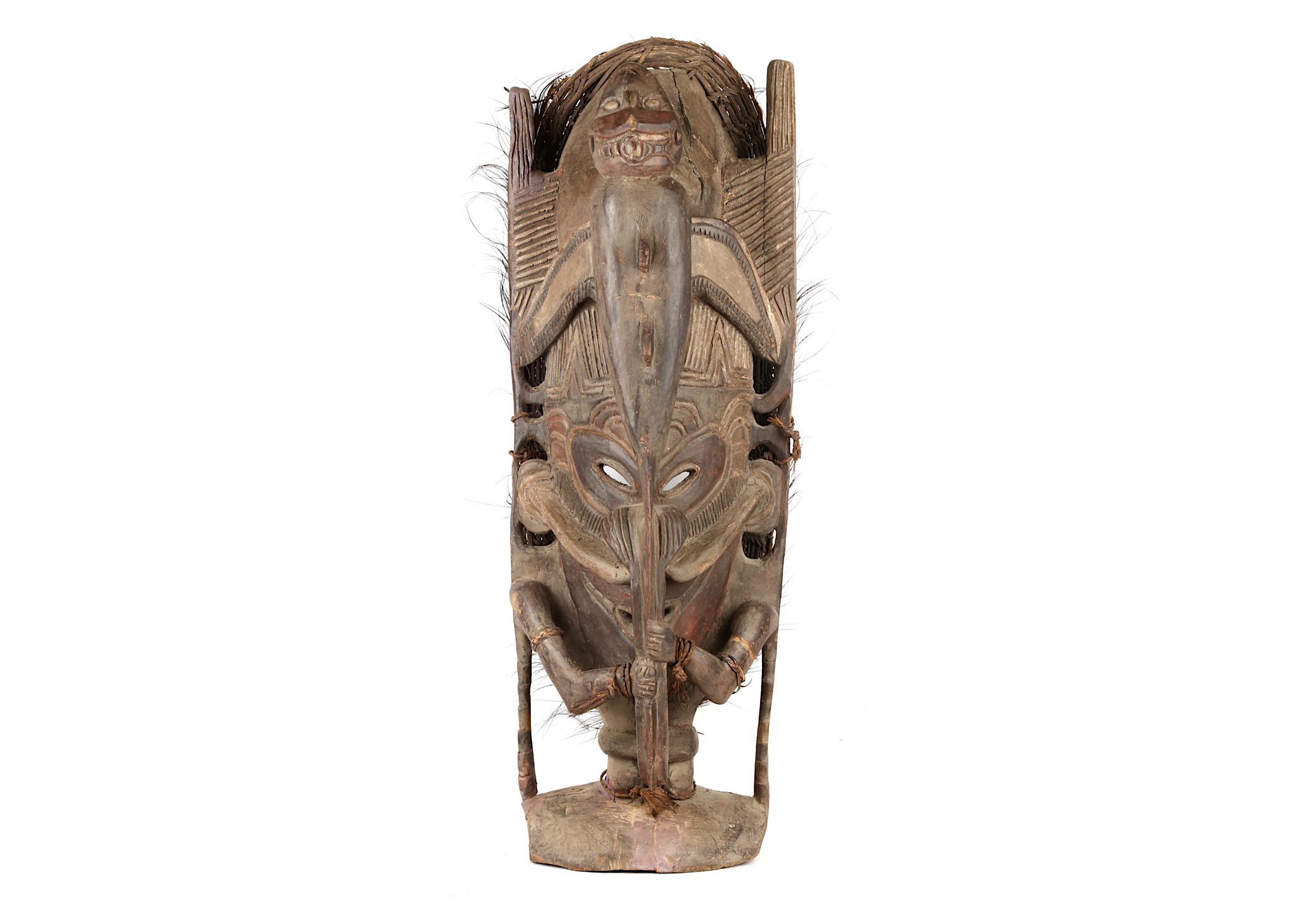 A SEPIK HOUSE POST FIGURE Carved in the shape of ancestor figure, with short legs, holding the