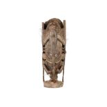 A SEPIK HOUSE POST FIGURE Carved in the shape of ancestor figure, with short legs, holding the