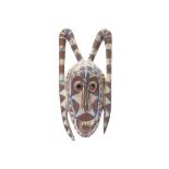 A HORNED MOSSI MASK, BOBO TRIBE, BURKINA FASO With an elongated ovoid face surmounted by two long