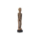 A MALE PHALLIC FIGURE Circa 19th Century, With elongated limbs and slender body, the face is