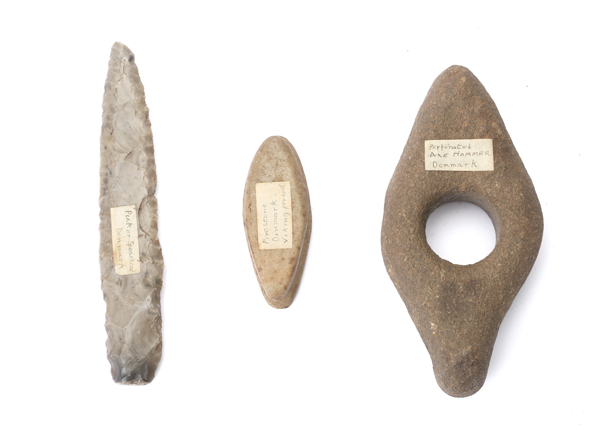 A GROUP OF PREHISTORIC IMPLEMENTS  Including a long narrow grey flint dagger that tapers to a