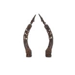 TWO BENIN BRONZE TUSKS Large curved bronze tusks with openwork patterned design topped with