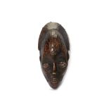 A CHOKWE MASK, DEMOCRATIC REPUBLIC OF CONGO With a large domed forehead, in the centre of which a