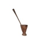 A LARGE WOOD PESTLE AND MORTAR With a deep mortar standing on a circular foot and an elongated