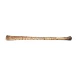 AN ESKIMO CARVED WHALE BONE CLUB  Circa 19th Century  A long club with a smooth surface with