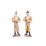 A pair of Oriental painted pottery figures