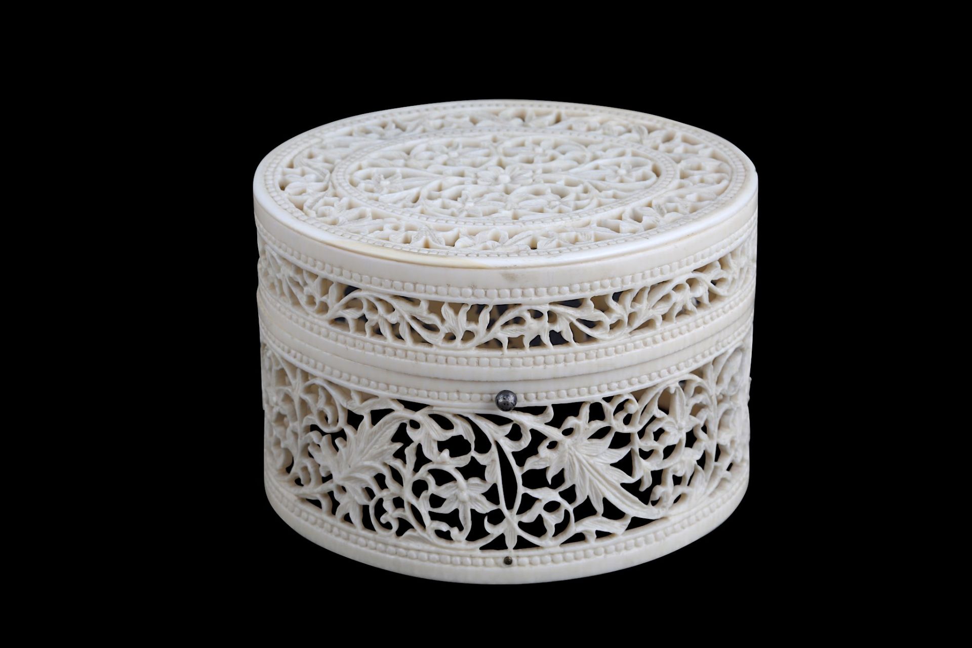 A CARVED AND PIERCED IVORY BOX India, late 19th century  Of oval shape, pierced ivory decoration