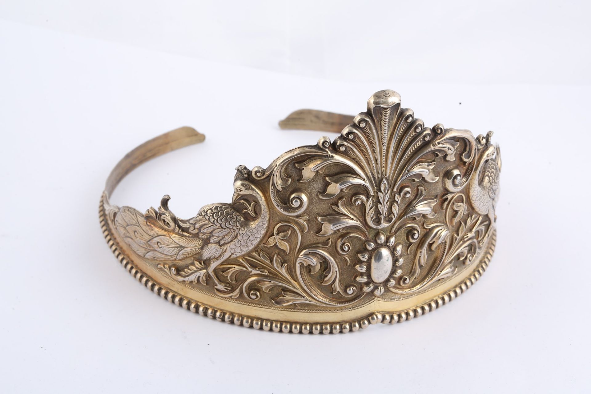 A PARCEL-GILT SILVER TIARA India, 19th century  Of typical circular form, the repoussé decoration - Image 6 of 7