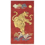 AN ANTIQUE TIBETAN RUG approx: 4ft.9in. x 2ft.7in.(145cm. x 79cm.) Very nicely drawn design with