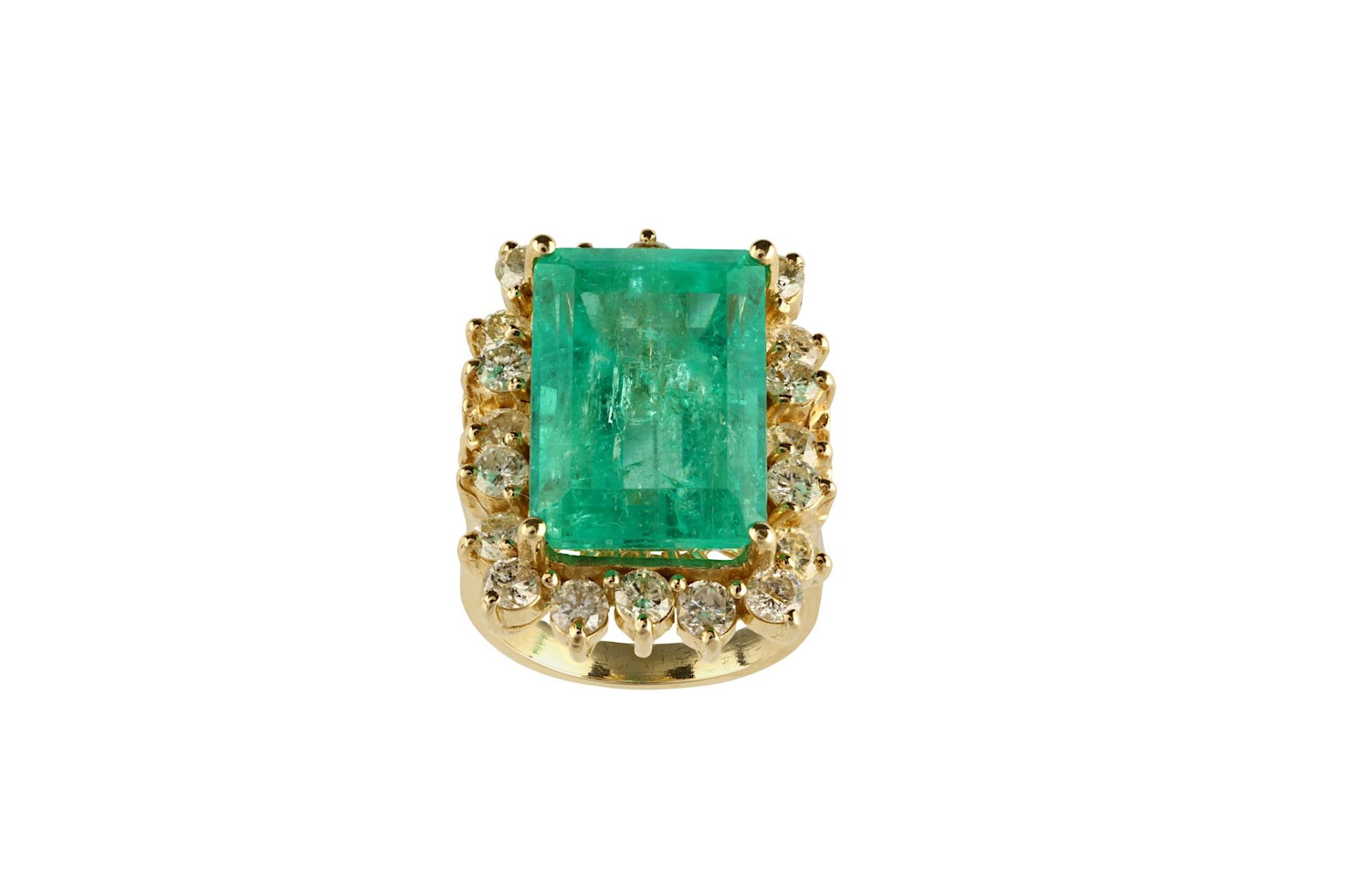 An emerald and diamond cluster ring