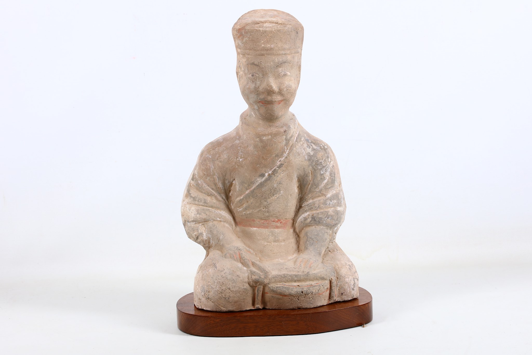 A Chinese earthenware figure of a musician on a wooden base, Han dynasty, 38cm high