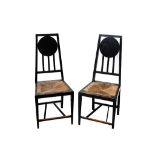 A pair of Mackintosh style ebonised side chairs, with drop in rush seats (2)