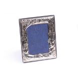 A contemporary hallmarked silver photograph frame, late 20th century, embossed with a fairytale