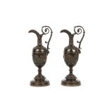 A pair of Italian Grand Tour bronze ewers, 19th century, both with a scrolling acanthus wrapped