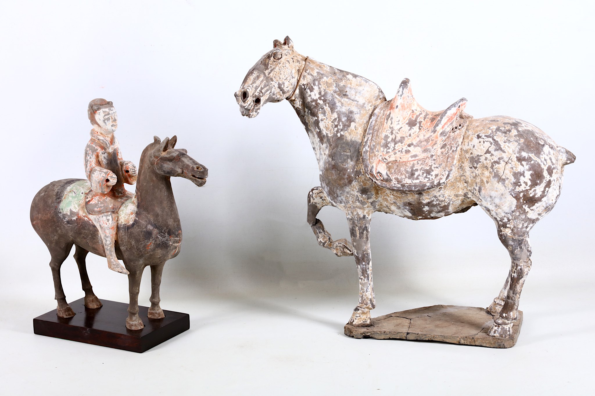 Two Chinese pottery horses, one with rider, Tang style, 41cm and 34cm high (2)