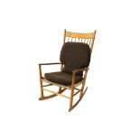 A Hans Wegner J16 beech rocking chair, with a comb back and woven sea grass seat