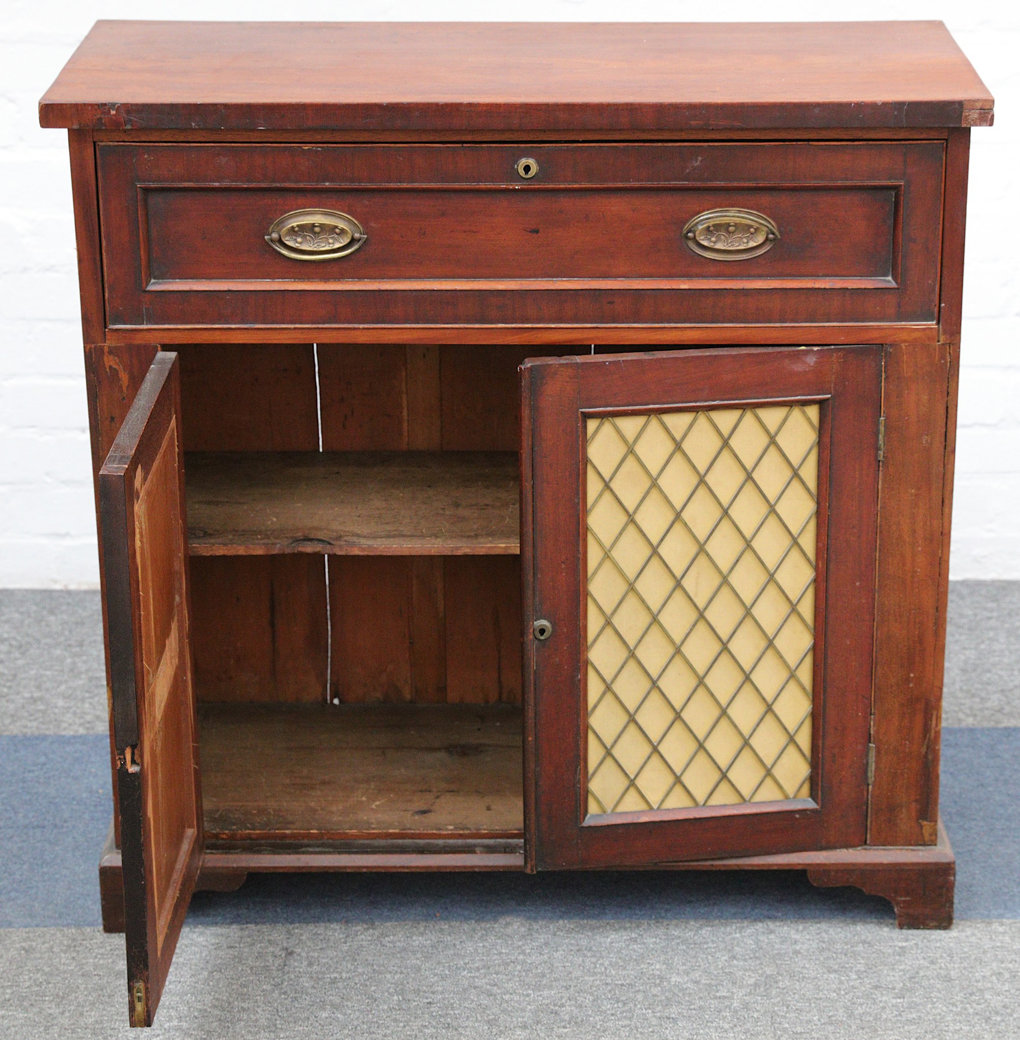 A Victorian mahogany secretaire cabinet, the maple faced interior over two brass grille doors, on