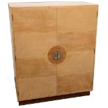 An Art Deco style maple and teak veneered two door side cabinet, the pigeonhole interior with fitted