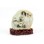 An oriental hardstone carving with wooden stand an