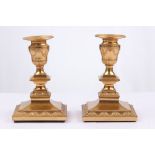 A good pair of French gilt bronze candlesticks, late 19th century, of square section, decorated with