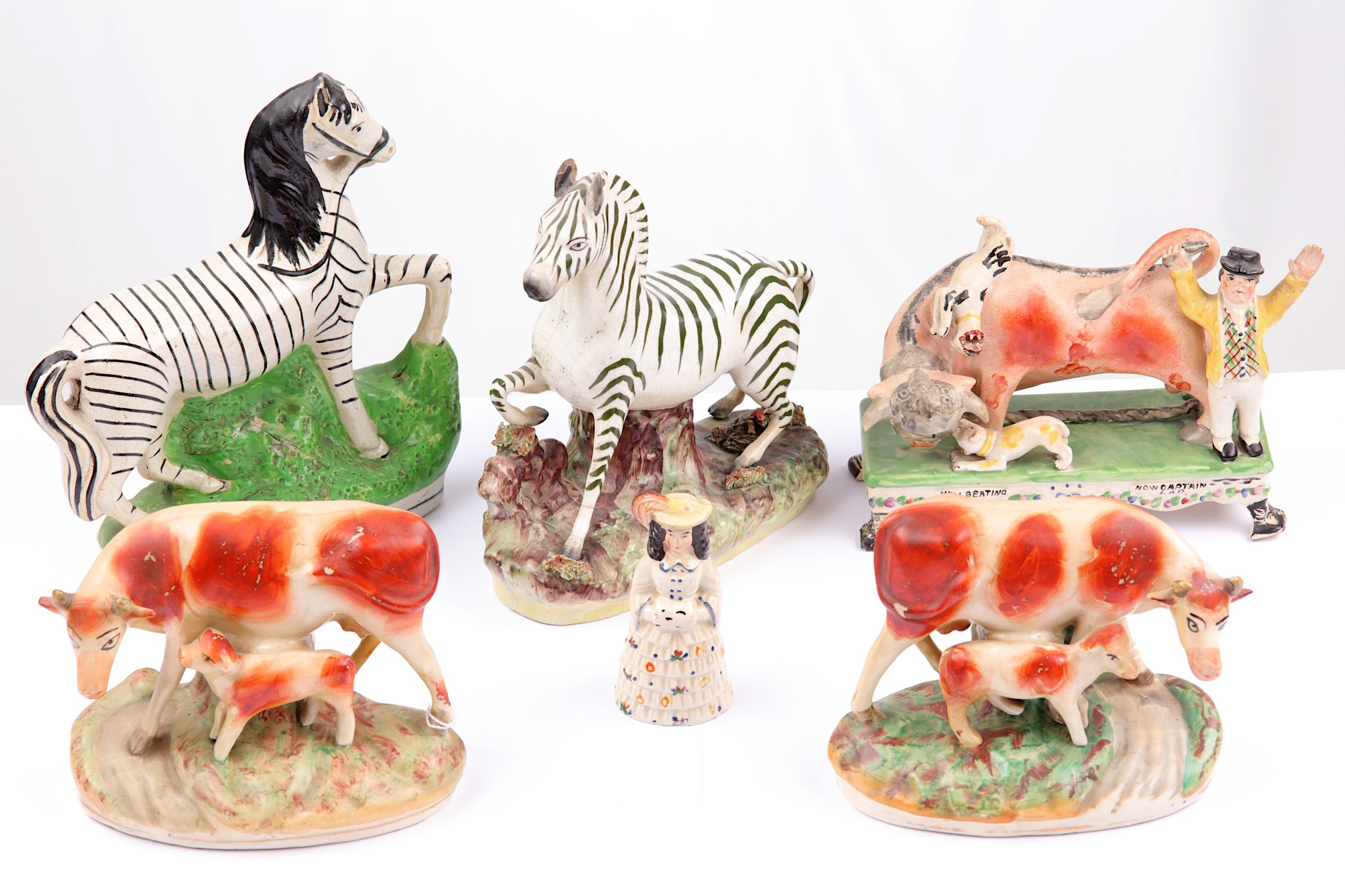 An interesting collection of Staffordshire pottery figures, 19th century, to include a bull
