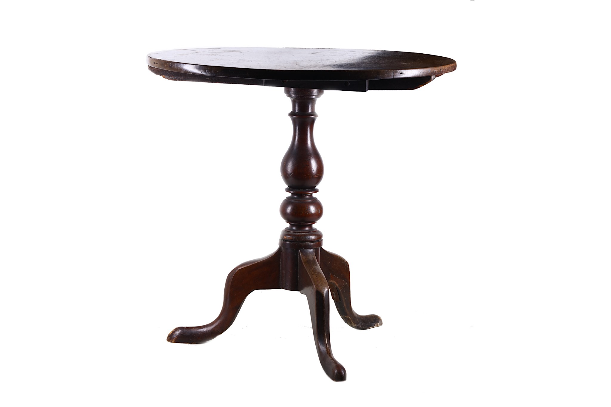 A provincial mahogany tea table, early 19th century, with a circular tilt top on a baluster pillar