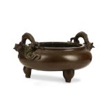 A LARGE CHINESE BRONZE TWIN HANDLED ‘DRAGON’ INCENSE BURNER. 17th Century. Of bombé form, supported