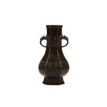 A CHINESE HEXAGONAL BRONZE VASE. Ming Dynasty. Of hexagonal form, the pear-shaped body rising from