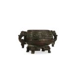 A CHINESE MINIATURE BRONZE GUI. Ming Dynasty. Standing on four paw feet issuing from animal masks