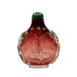 A CHINESE GLASS SNUFF BOTTLE. Qing Dynasty. Of compressed pear-shaped form, carved in relief to