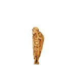 AN IVORY NETSUKE OF AN IMMORTAL. 18th Century. Standing with his staff, looking to the right,