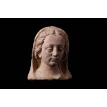 A 17TH CENTURY ITALIAN TERRACOTTA HEAD OF THE VIRGIN with serene expression and heavily lidded eyes,