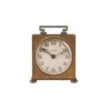 AN EARLY 20TH CENTURY GILT BRASS DESK ALARM CLOCK BY ZENITH of square form with engine turned