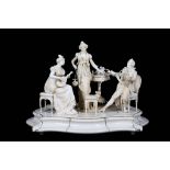 A LARGE LATE 19TH CENTURY GERMAN / AUSTRIAN CARVED IVORY FIGURAL GROUP OF AN INTERIOR SCENE