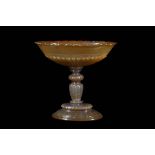 A 19TH CENTURY GERMAN CARVED AGATE TAZZA the shallow bowl with scallop edge and lobed base, carved
