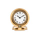 A LATE 20TH CENTURY GILT METAL DESK ALARM CLOCK BY CARTIER the circular, moulded case with strut