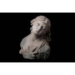 A 17TH CENTURY ITALIAN TERRACOTTA BUST OF AN ANGEL  his eyelids delineated and lips slightly parted,